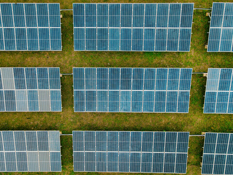 Aerial view of rows of solar panels installed in a grassy field in Ogun State, Nigeria.
