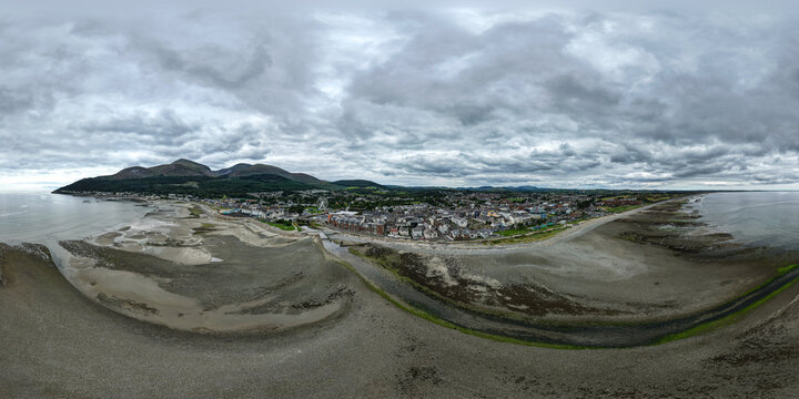 Aerial panorama of the town of Newcastle nestled against the Mourne Mountains with sandy but also rocky beaches and urban architecture In Newcastle Co. Down Northern Ireland U.K.