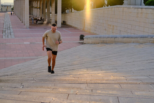 general shot of Latino man running stairs for fitness in barcelona