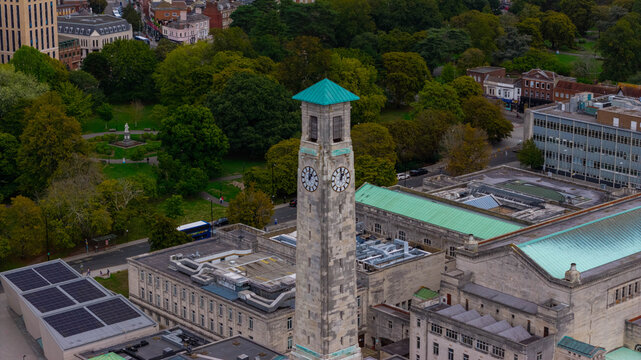 Aerial view of the historic Southampton Civic Centre clock tower surrounded by lush green parkland and urban architecture in Southampton, England, United Kingdom.