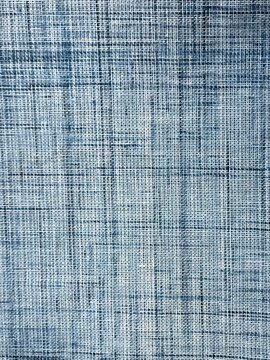 Blue woven fabric texture with detailed threads and subtle variations in shade and pattern
