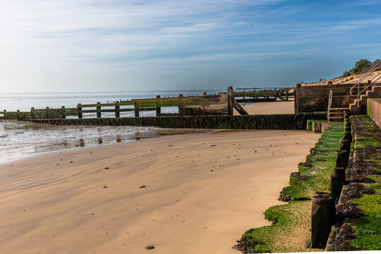 Wooden and concrete groynes are used along the beach at Walton-on-the-Naze as a form of hard coastal engineering to stop longshore drift and reduce beach erosion. Shot 21 September 2026.