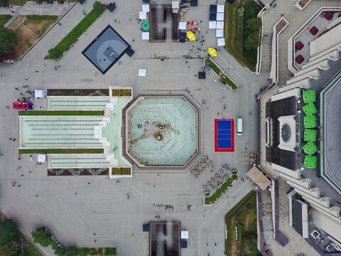 Aerial view of the NDK square featuring an octagonal fountain, geometric paving patterns, and people walking around the National Palace of Culture in Sofia, Sofia City Province, Bulgaria.