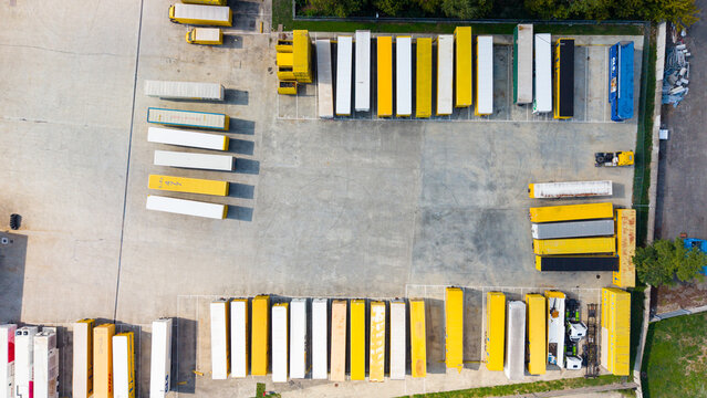 Aerial view of rows of dry van trailers parked at a logistics facility in Milan, Lombardy, Italy.