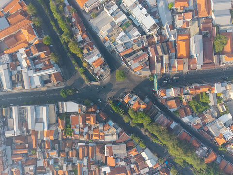 Aerial view of the historic Surabaya old town featuring dense urban architecture, terracotta rooftops, and intersecting streets in Surabaya, East Java, Indonesia.