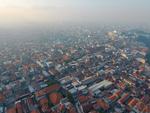 Aerial view of the historic Surabaya old town featuring dense terracotta-tiled rooftops and urban architecture in Surabaya, East Java, Indonesia.