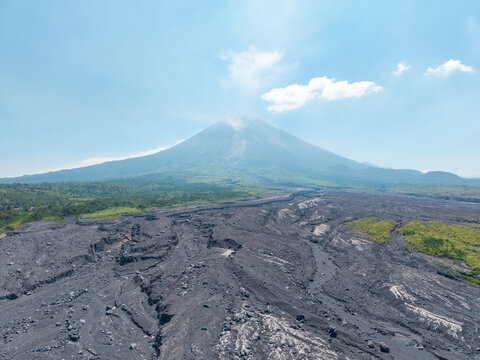 Aerial view of Mount Semeru with volcanic ash deposits and scarred landscape following a catastrophic eruption near Supiturang Village in Pronojiwo, East Java, Indonesia.