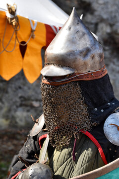 Medieval warrior with a conical helmet and chainmail face curtain