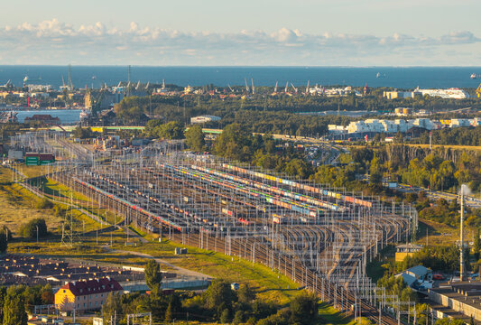 Gdansk, Poland - 23 September 2026: Aerial view of the extensive railway marshalling yard with numerous freight tracks, colorful cargo containers, and industrial infrastructure.