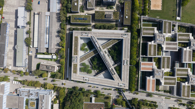 Unterfohring, Germany - 12 September 2026: Aerial view of Allianz Commercial headquarters featuring a distinct triangular building design with green courtyards and surrounding office structures.