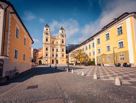 Attractive autumn view of Basilika St. Michael Catholic church. Marvelous afternoon cityscape of Mondsee townt, Vocklabruck district in the Austrian state of Upper Austria. 