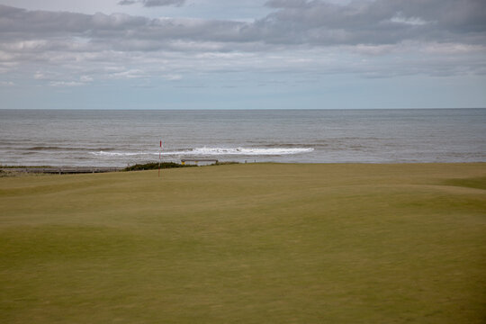 Inverness, Canada - September 18, 2026: Golf flag stands on a green overlooking the Gulf of St. Lawrence at Cabot Links