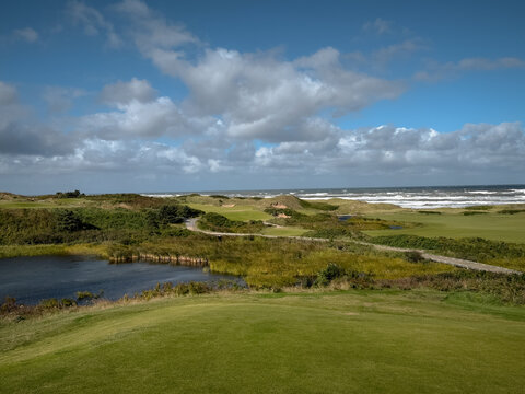 Inverness, Canada - September 18, 2026: Elevated teeing area overlooks rolling terrain, vegetation and water at Cabot Cliffs golf course.