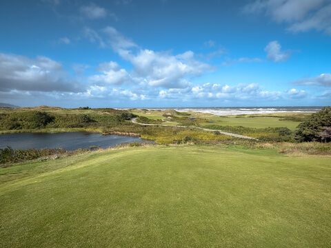 Inverness, Canada - September 18, 2026: Elevated teeing area overlooks rolling terrain, vegetation and water at Cabot Cliffs golf course.