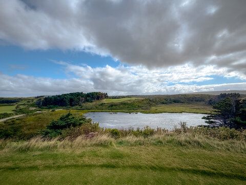 Inverness, Canada - September 18, 2026: Elevated teeing area overlooks rolling terrain, vegetation and water at Cabot Cliffs golf course.