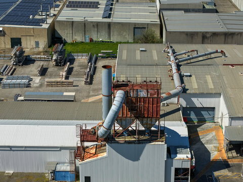 Kilsyth, Australia - 20 September 2026: Aerial view of an industrial factory complex featuring large metal ventilation ducts, machinery, and solar panels on rooftops.