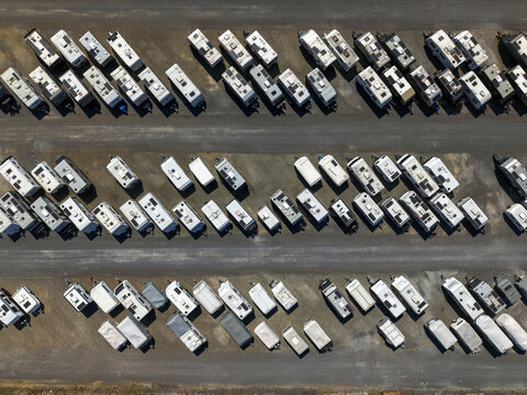 Kilsyth, Victoria, Australia - 20 September 2026: Aerial view of numerous caravans and trailers parked in orderly rows on a gravel lot.