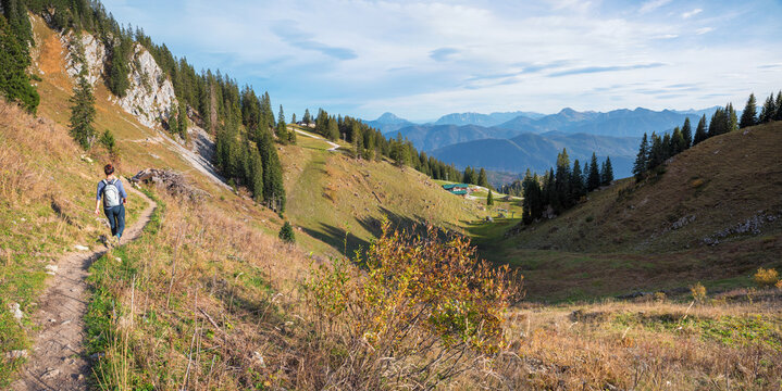 young woman at hiking trail Brauneckmountain, autumnal landscape upper bavaria