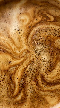 Abstract top view of fresh espresso coffee crema texture with foam and bubbles