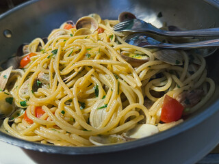 Spaghetti alle vongole with clams and cherry tomatoes, Italian pasta close-up, traditional seafood recipe © cristian
