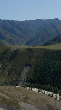 Drone footage of mountain valley and river channel near the confluence of the Chuya and Katun rivers, Altai Republic, Russia, on a sunny summer day