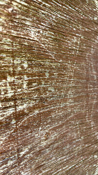 Vertical of weathered wooden wall with flacked brown paint focus fades in the distance
