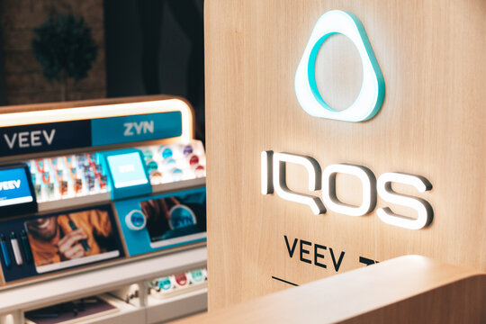 2 August 2026, Belgrade, Serbia: Logos for IQOS, VEEV, and ZYN displayed in a modern retail setting, showing nicotine and tobacco alternative products