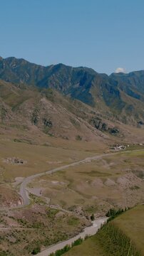Drone footage of the confluence of the Chuya and Katun rivers in the Altai Republic, Russia, with mountain ridges, winding riverbed and open steppe valley