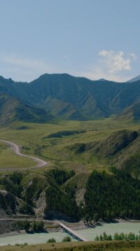 Drone footage of the confluence of the Chuya and Katun rivers, turquoise water winding through a mountain valley near Inya, Altai Republic, Russia