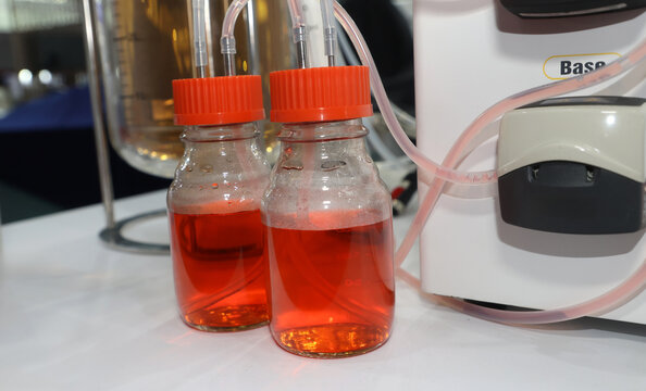 Laboratory bioreactor system with acid and base reagent bottles