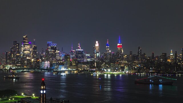 During USA 250 celebration, New York City skyline rises in a dazzling wall of light beyond waters of the Hudson River. 