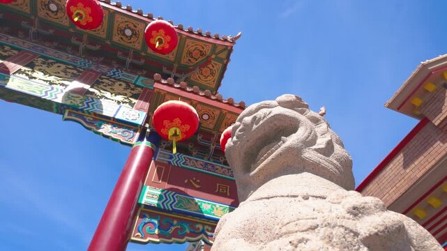 Victoria, British Columbia, Canada - September 26, 2026: Low angle view of the Gate of Harmonious Interest stone lion in Chinatown