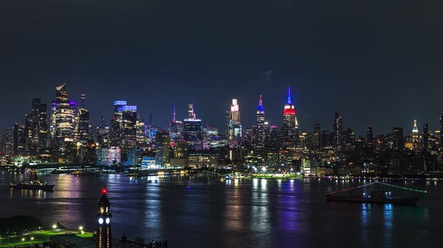 In USA 250 years celebration, the New York City skyline rises in a dazzling wall of light beyond the dark waters of the Hudson River 