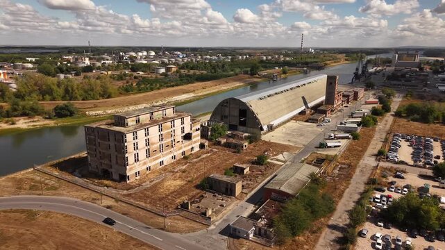Aerial orbit around oval abandoned industrial building