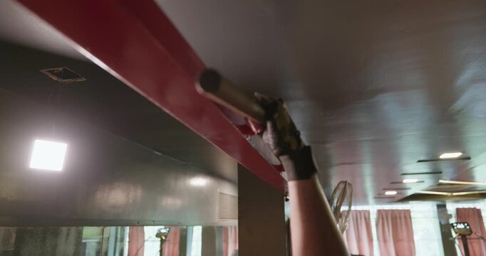An Indian male athlete performs strict pull-ups on a pull-up bar in a modern gym. He uses controlled bodyweight movements to build back, shoulder, and arm strength
