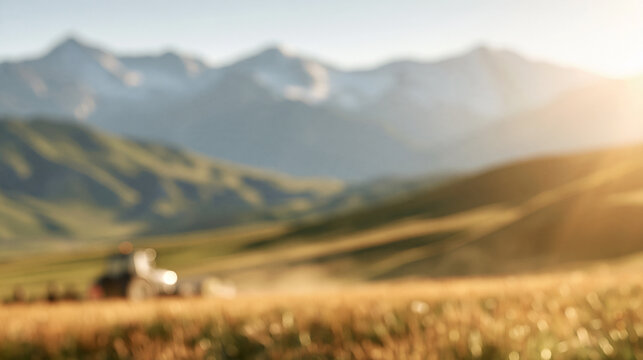 Farming tractor working in golden field with mountains at sunset blurred background