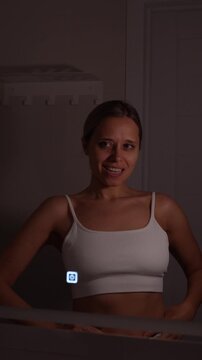 Young woman speaking affirmations in the mirror, gesturing confidently and practicing self love during a morning bathroom routine