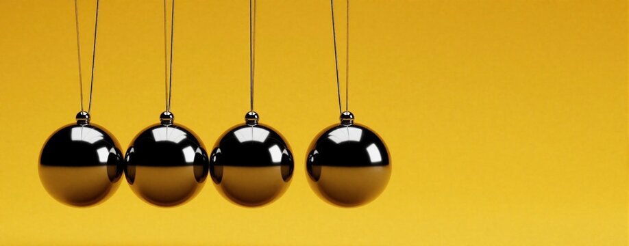 Newton cradle with four shiny metal balls hanging on black strings. Steel pendulums swing against bright yellow background. Physics concept shows energy conservation, motion, momentum. Minimalist