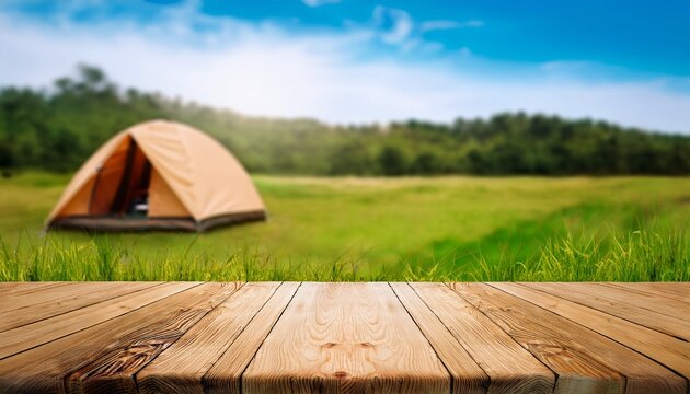 wooden table in blur camping tent and grass field cool and relaxing concept for product display montage or key visual layout design space for text