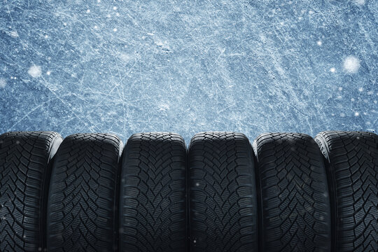 Tire at ice background. Winter tire isolated on free ice background.