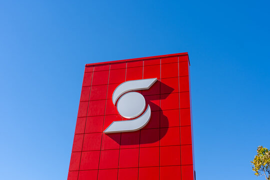 Oshawa, Ontario, Canada - September 26, 2026: A red exterior sign and logo of a Scotiabank branch against a clear blue sky. Oshawa, Ontario, Canada. 