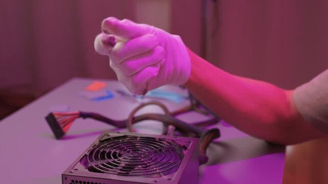 Technician cleaning computer. Expert cleaning and examining computer hardware meticulously. Technician carefully clearing dust from open computer with specialized tools