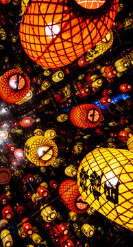 Chinese lanterns illuminated on the ceiling reflecting in the mirrors