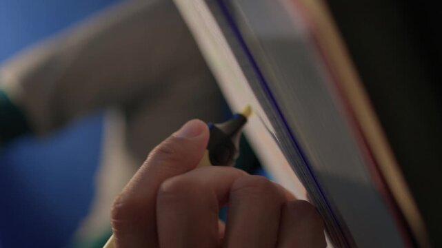 Individual concentrates while reviewing documents quietly. Lone individual carefully examines handwritten notes under gentle illumination during late night hours at home