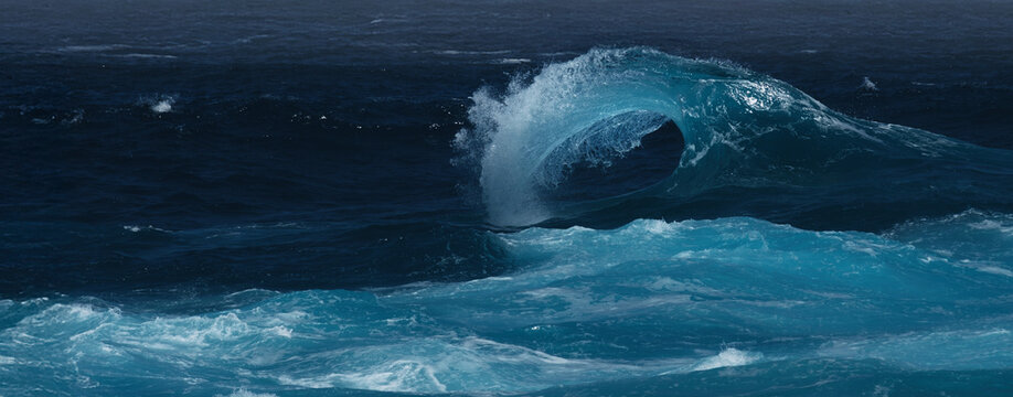 Powerful Turquoise Ocean Wave Curling Over Deep Blue Water