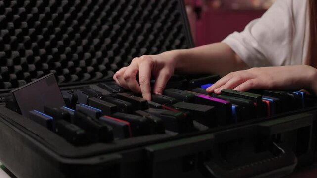Precise sorting of multiple external storage devices in orderly rows. Systematic placement of various external hard discs emphasizing organization and cataloging principles
