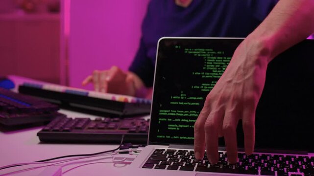 Solo software engineer working through technical issues late at night. Dedicated coder in dim lighting diagnosing problems on open computer case with intense concentration