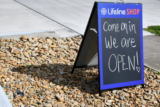 Lifeline charity shop with signage at entrance come on in we are open