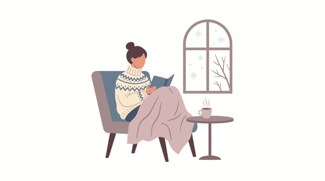 A cozy woman sitting in an armchair reading a book during a snowy winter day.