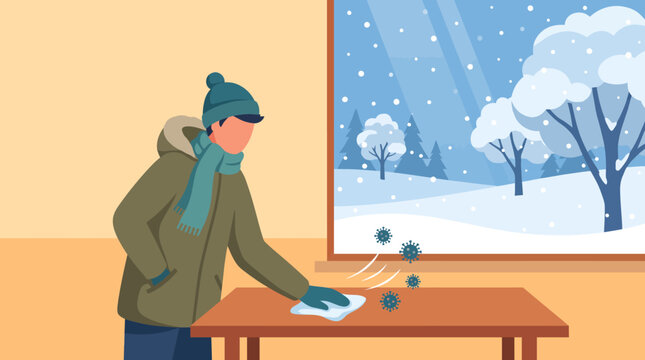 A person wearing winter clothes cleaning a table surface with a cloth during the cold season.